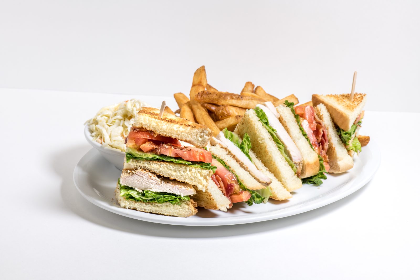 Club sandwich with fries and coleslaw
