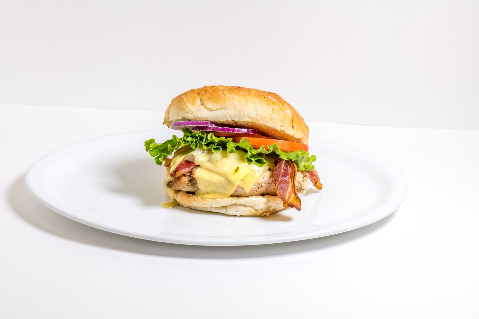 Burger with bacon, lettuce and red onion